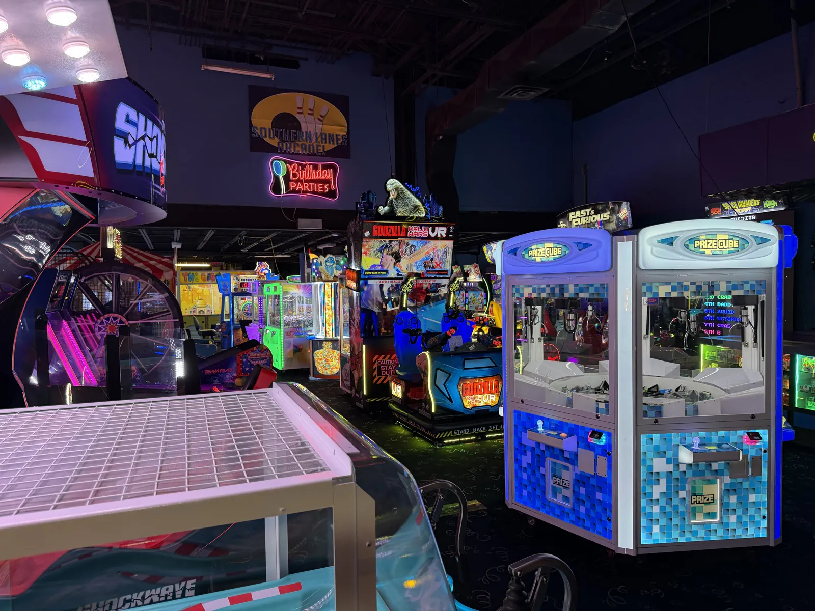 Colorful arcade floor with redemption, racing, action, and prize games at Southern Lanes Bowling Green