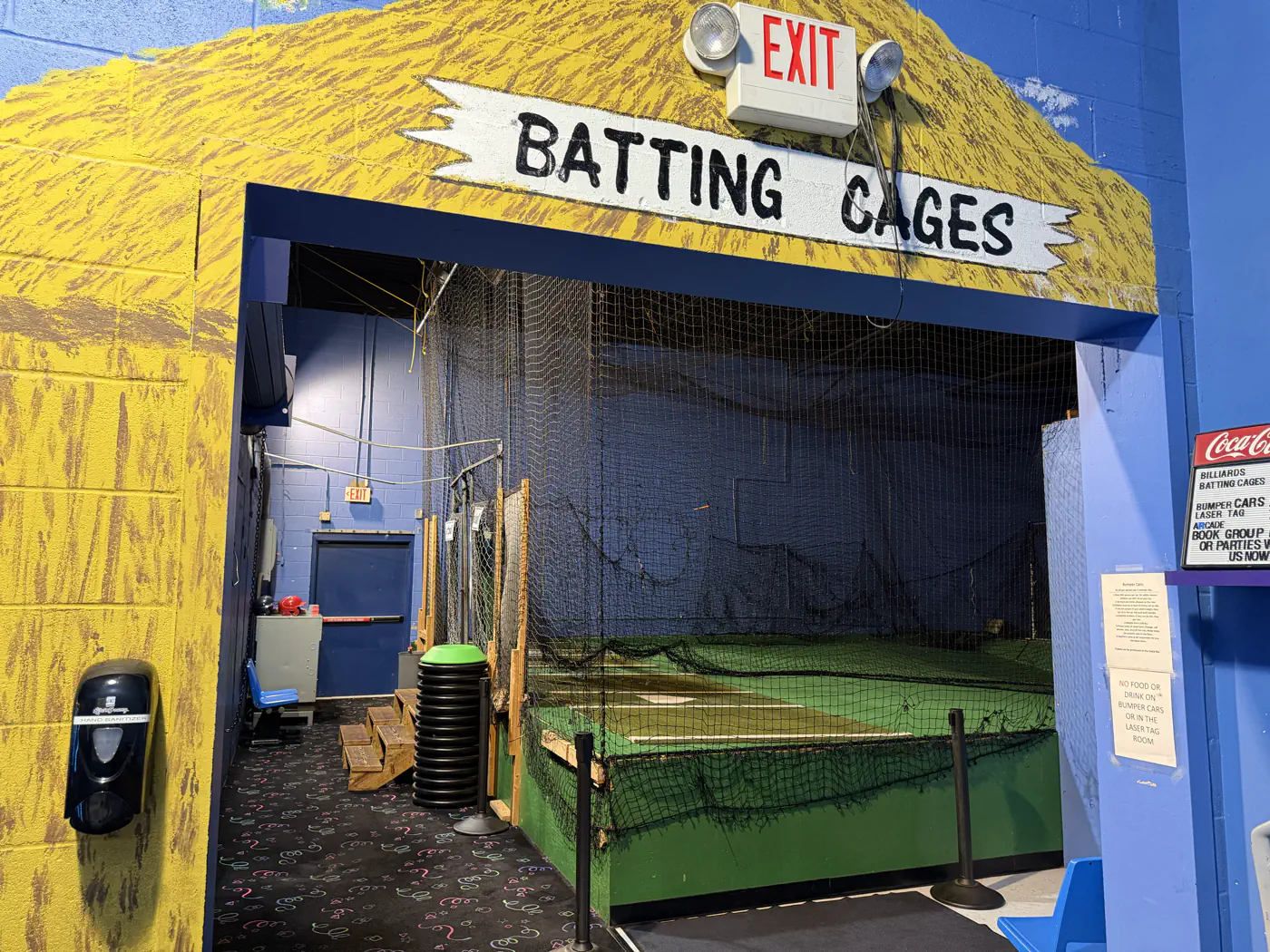 Indoor netted batting cage entrance and green turf at Southern Lanes Bowling Green