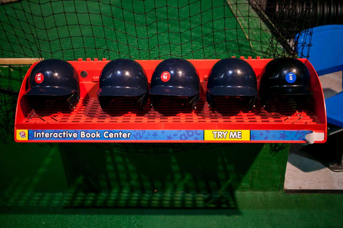 Batting helmets and equipment beside the indoor batting cages at Southern Lanes