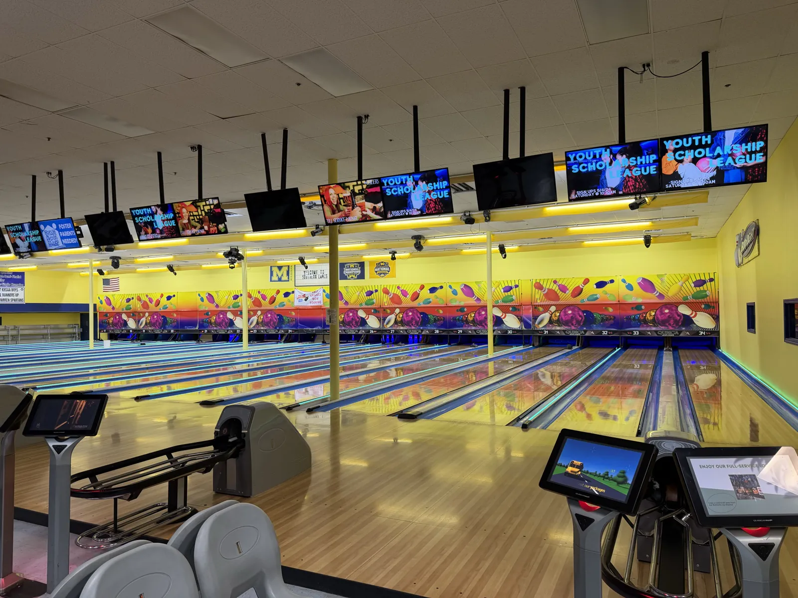 Bright bowling lanes, scoring screens, ball returns, and seating inside Southern Lanes Bowling Green