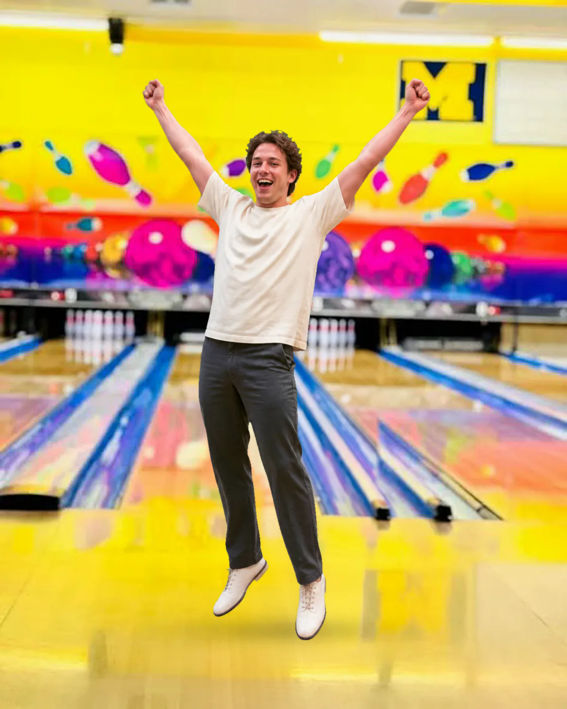 Smiling bowler raising both arms inside Southern Lanes Bowling Green
